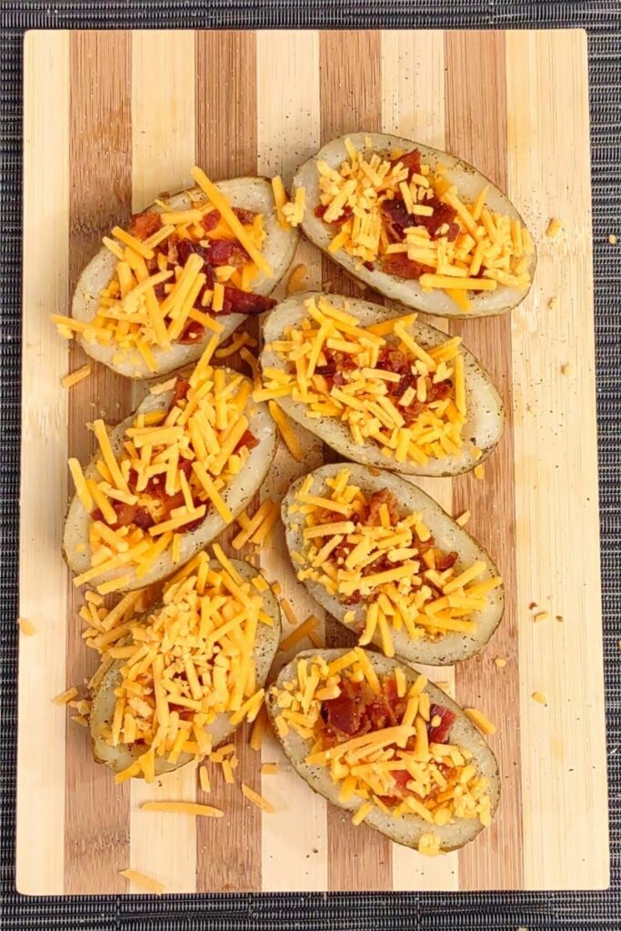 add cheddar cheese and bacon to potato skins