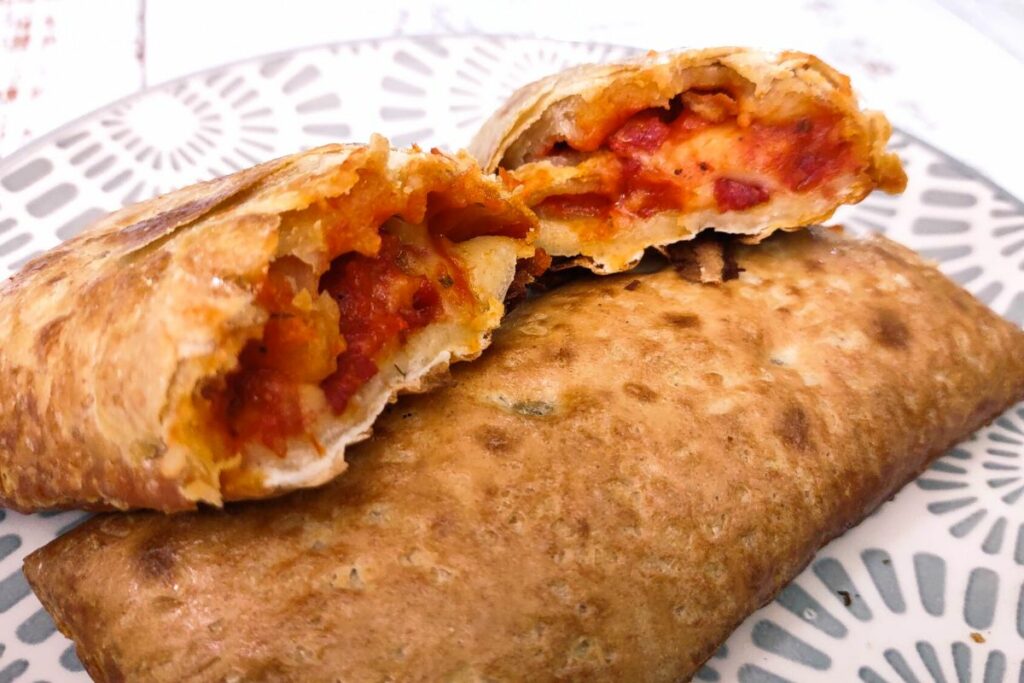 pepperoni hot pocket cut in half and spread open on top of a second air fried hot pocket