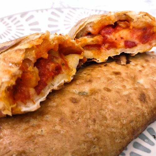 pepperoni hot pocket cut in half and spread open on top of a second air fried hot pocket