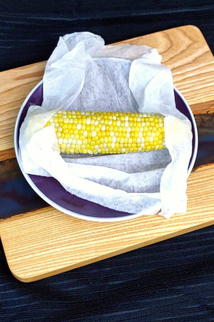 carefully unwrap corn on the cob from paper towel