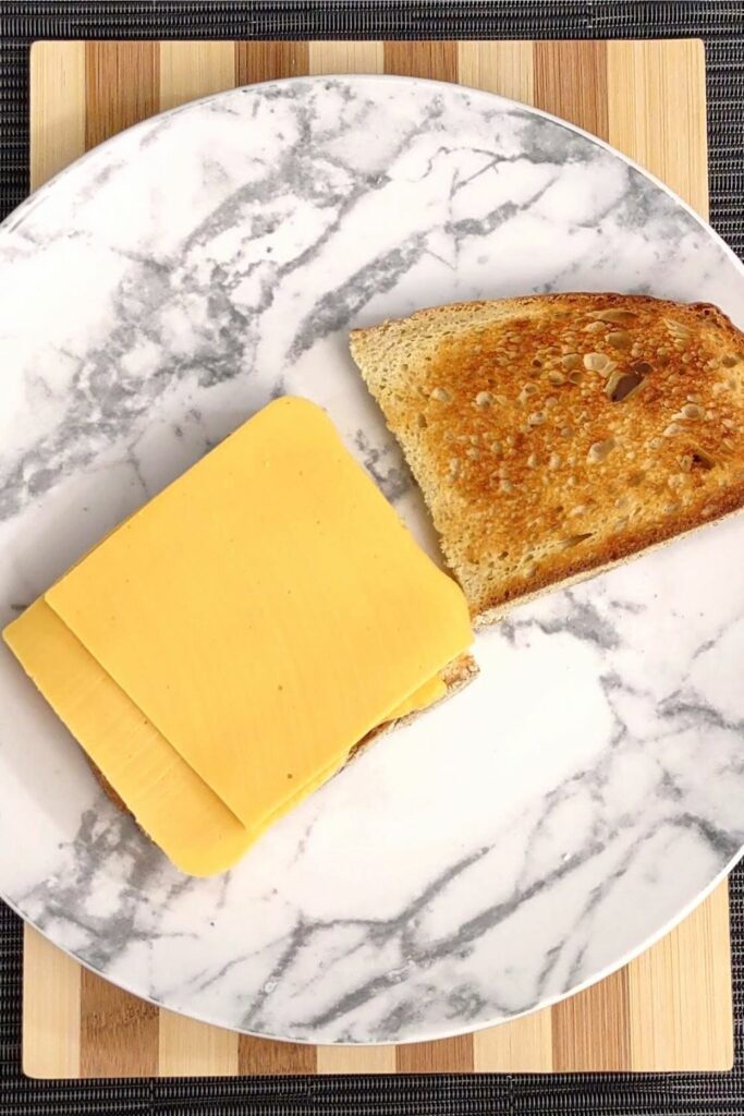 place two slices of cheese on your toasted bread