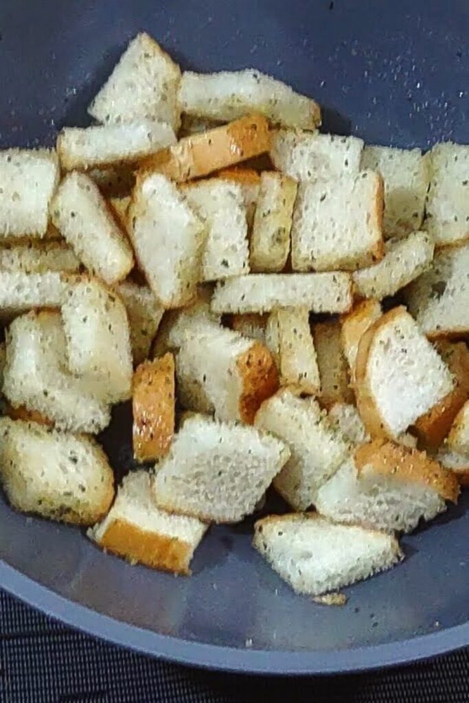 toss bread cubes in mixing bowl with oil and seasoning