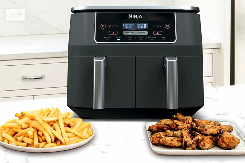 ninja foodi dual zone air fryer with french fries and chicken wings