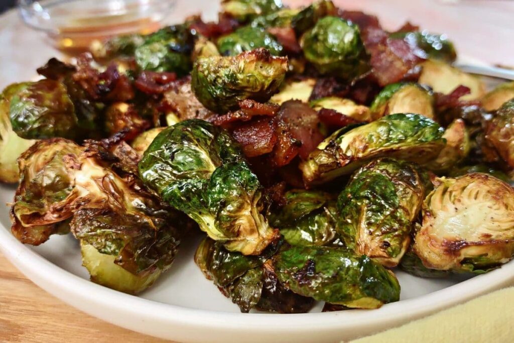 closeup of air fryer brussel sprouts with bacon on a plate