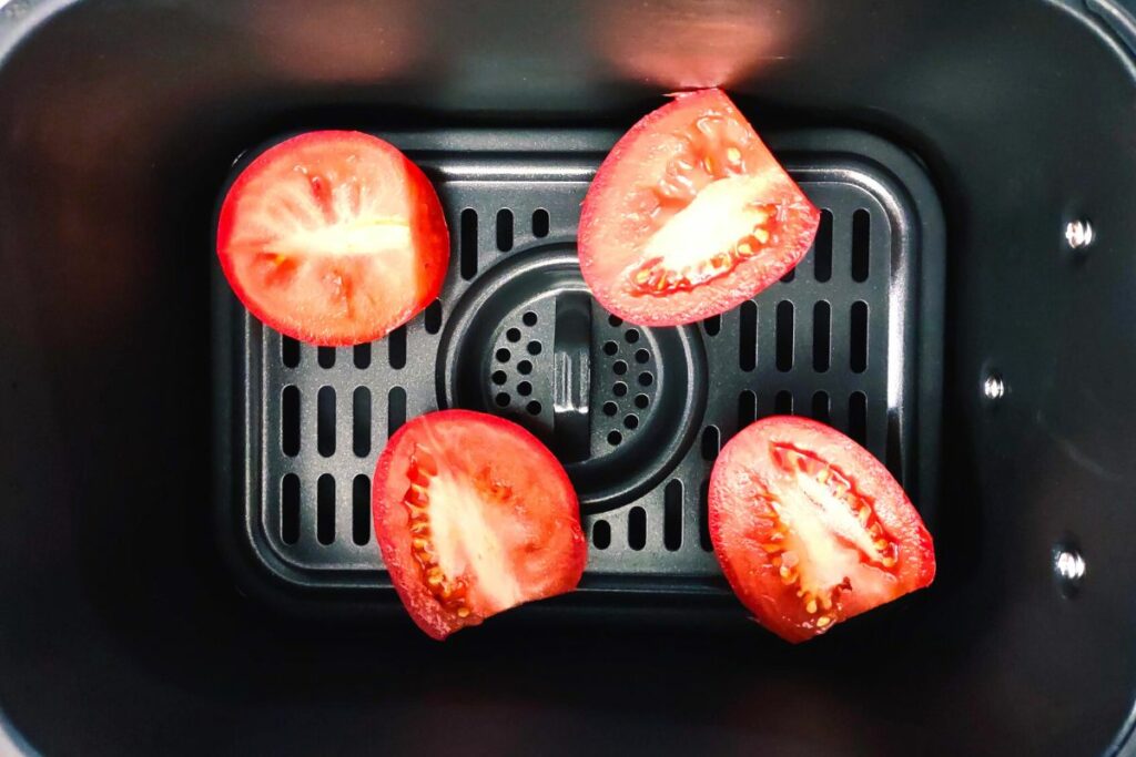 cut large tomatoes in half and place them in air fryer basket