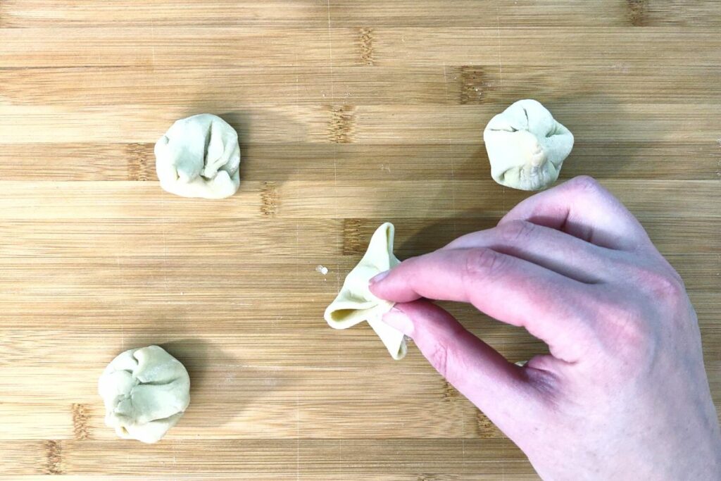 fold the corners of the puff pastry and pinch closed