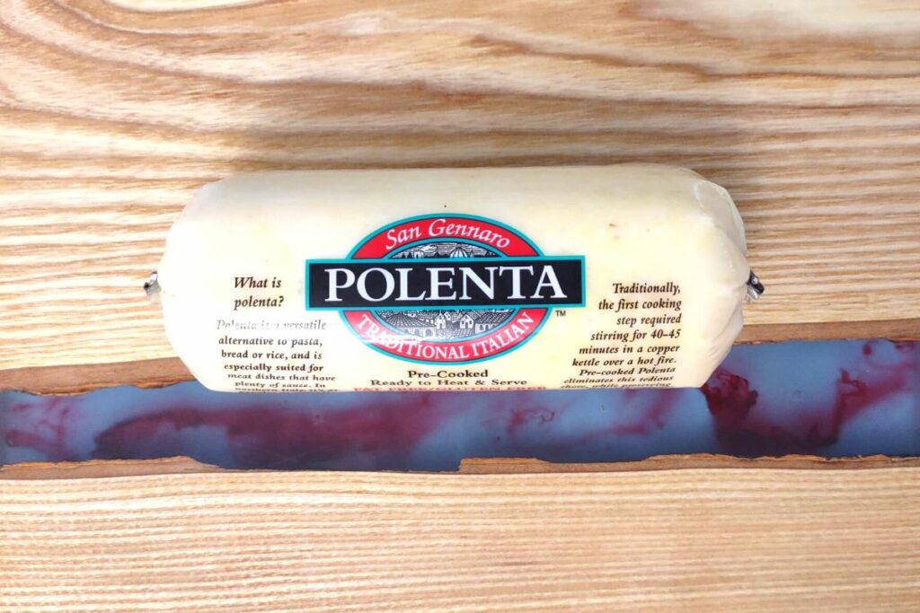 polenta tube in casing on a cutting board
