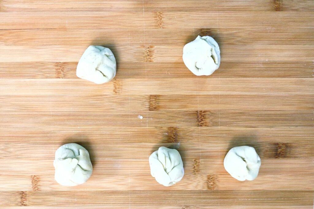 push down the tops of the pinched puffed pastry to look like dumplings