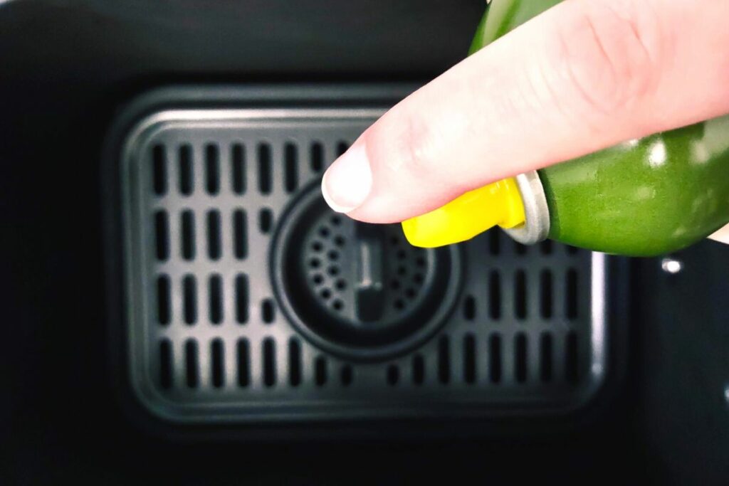 spray air fryer basket with oil to prevent sticking