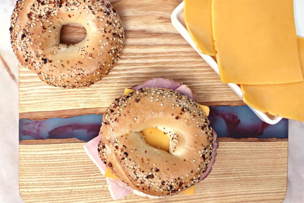 add the top of the bagel to the ham and cheese