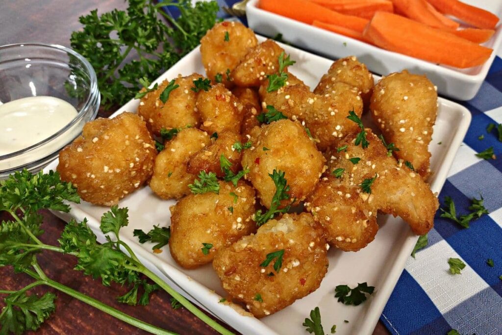 air fryer buffalo cauliflower wings with a side of carrots and ranch dipping sauce