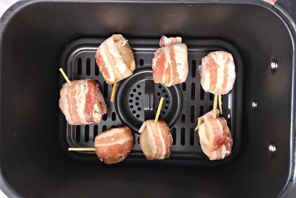 bacon wrapped scallops in the bottom of air fryer basket