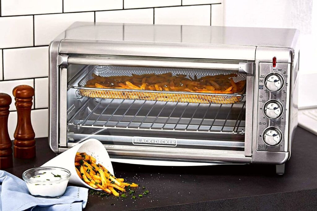 silver black and decker toaster oven on a counter with french fries inside