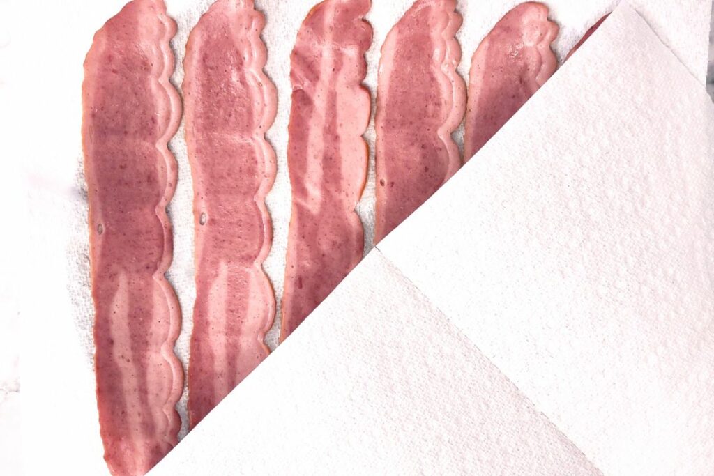 cover the uncooked turkey bacon with a second paper towel