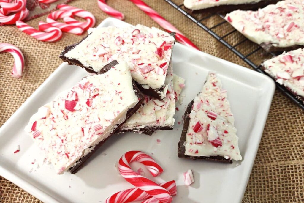 plate of peppermint bark with mini candy canes surrounding the plate