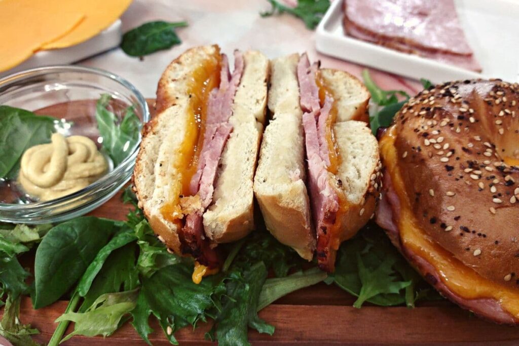 hot ham and cheese bagel sandwich cut in half