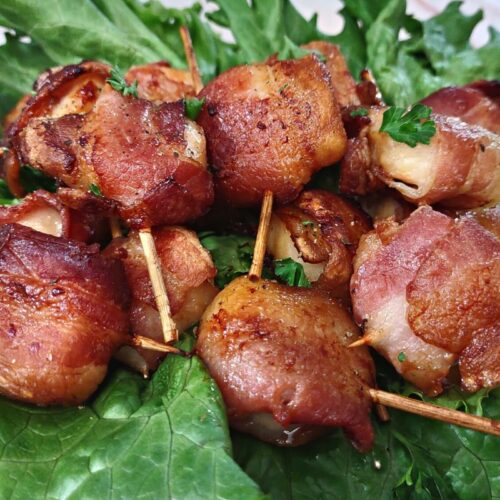 air fried bacon wrapped scallops on a bed of lettuce