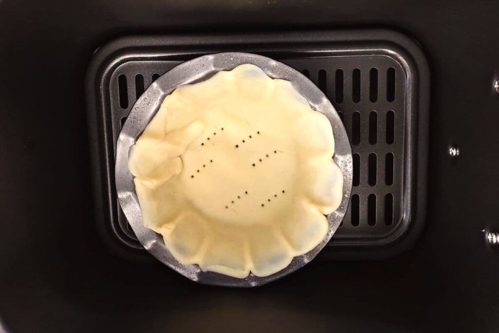 place uncooked crust in pans in air fryer basket