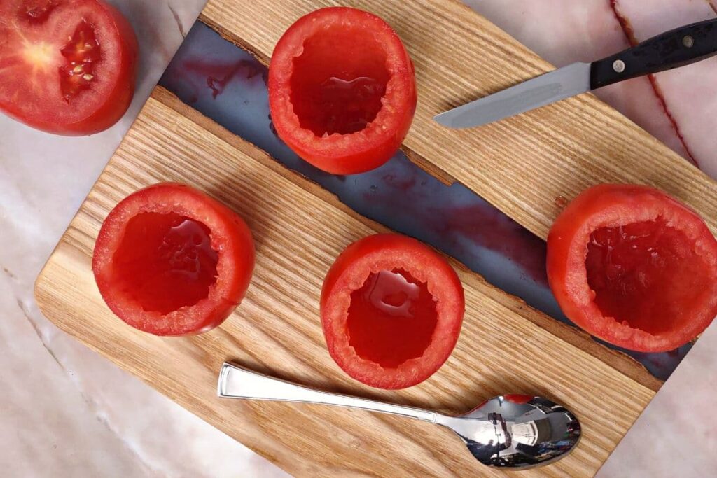 carefully scoop out the tomato filling without damaging the walls