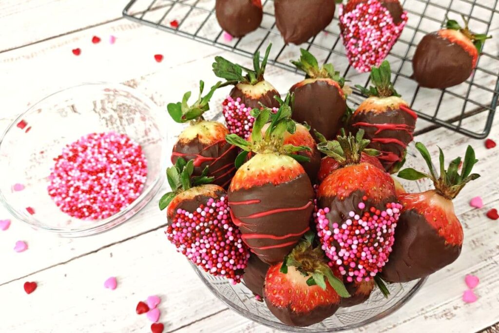 chocolate covered strawberries in a glass bowl with sprinkles
