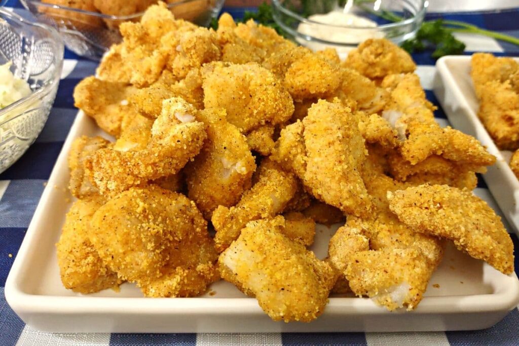 closeup of air fryer catfish nuggets on a white square plate