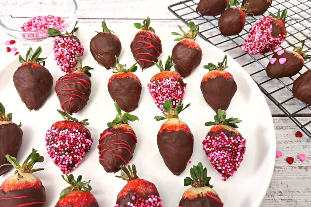 chocolate covered strawberries lined across a white circular plate
