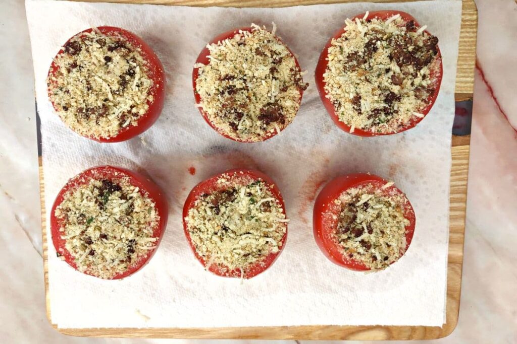 fill tomatoes with stuffing mixture and pack it down