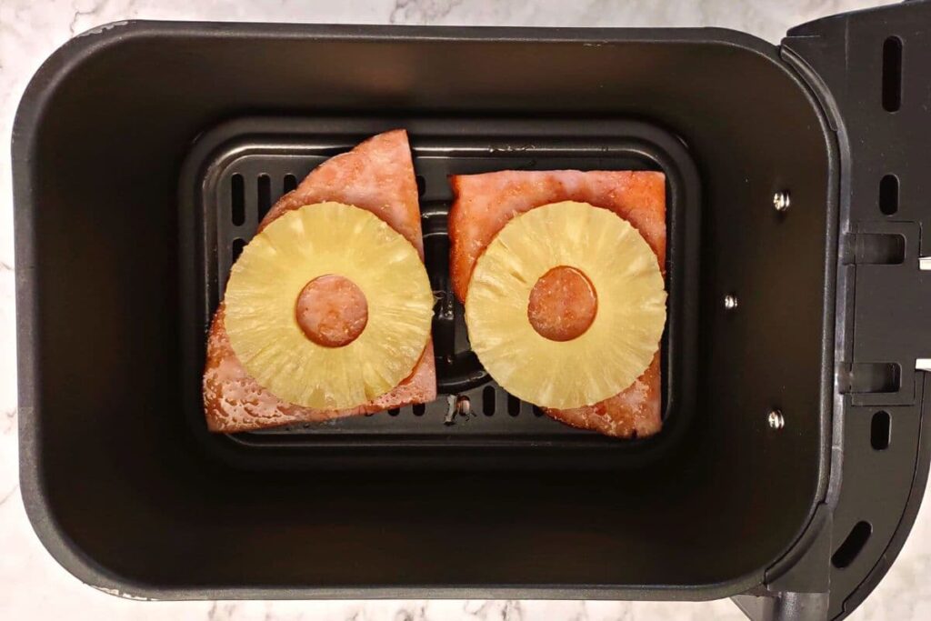 flip ham steak in air fryer basket and add pineapple slices