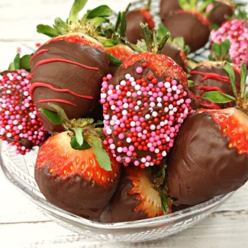 closeup of chocolate covered strawberries in a glass bowl