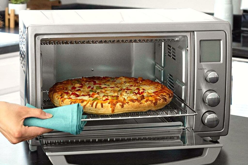 removing a pizza from a black and decker air fryer toaster oven
