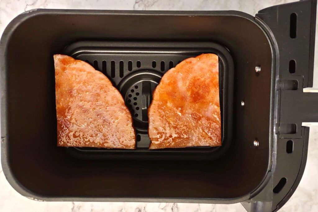 place ham in air fryer basket and begin to cook