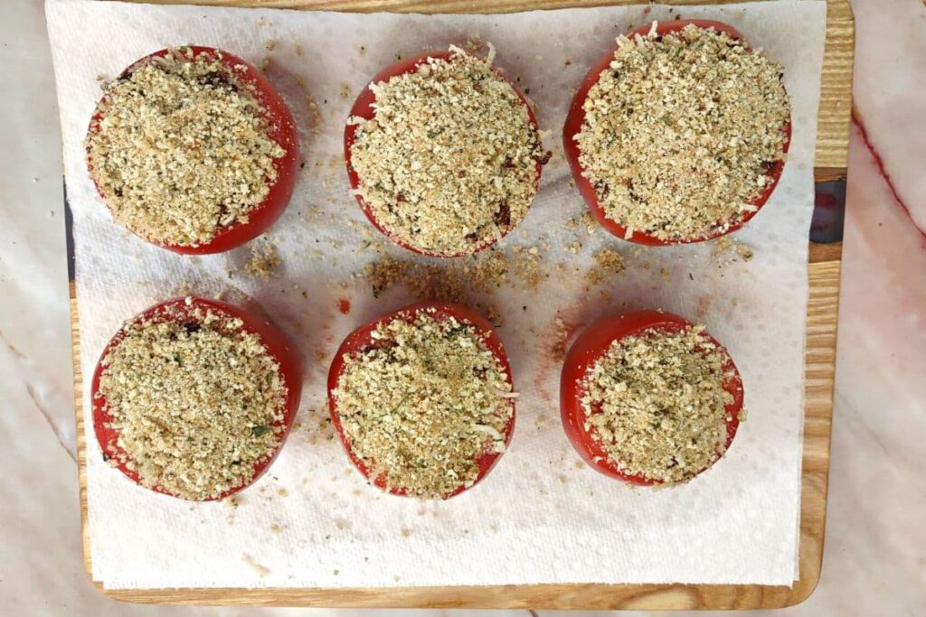 top the stuffing filled tomatoes with the remaining breadcrumbs