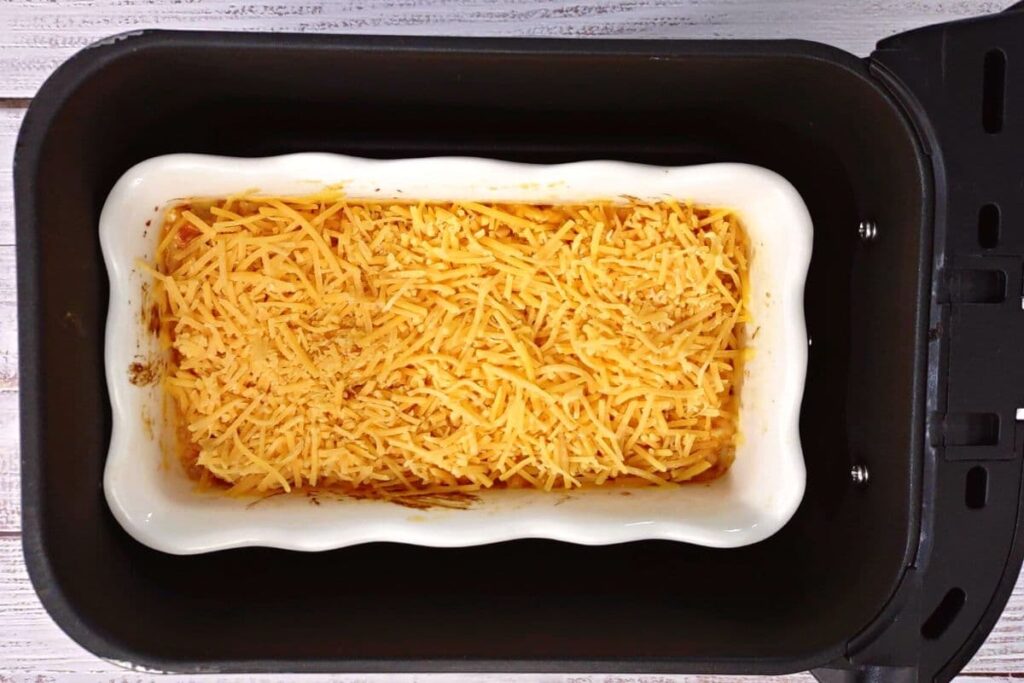 add remaining cheese to top of buffalo chicken dip and continue cooking