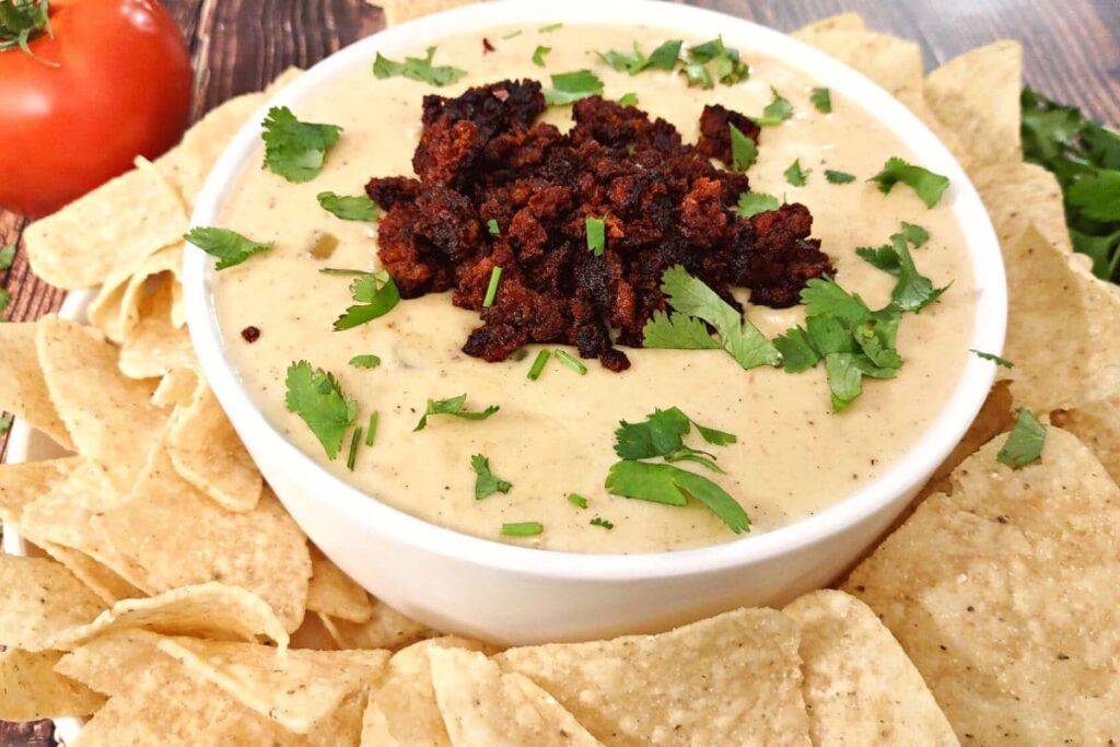 air fryer queso cheese dip topped with chorizo surrounded by chips