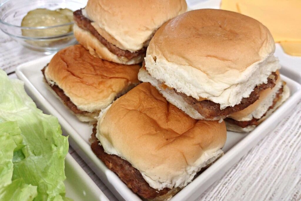angled view looking at white castle burgers stacked on a plate