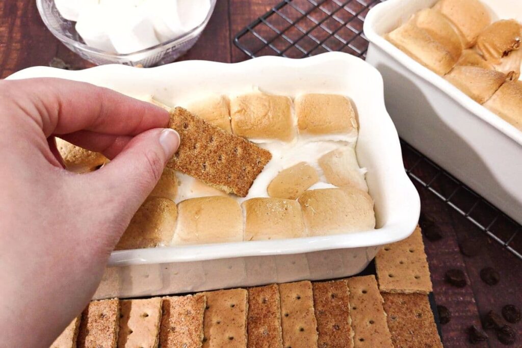 dipping a graham cracker into marshmallow dip