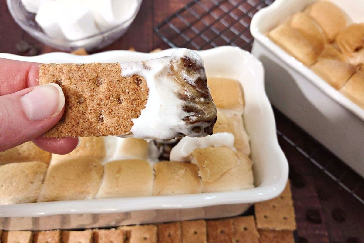graham cracker with air fryer smores dip dripping off the end
