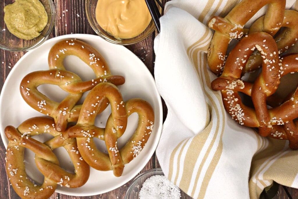 overhead view of air fryer soft pretzels on a plate and in a basket