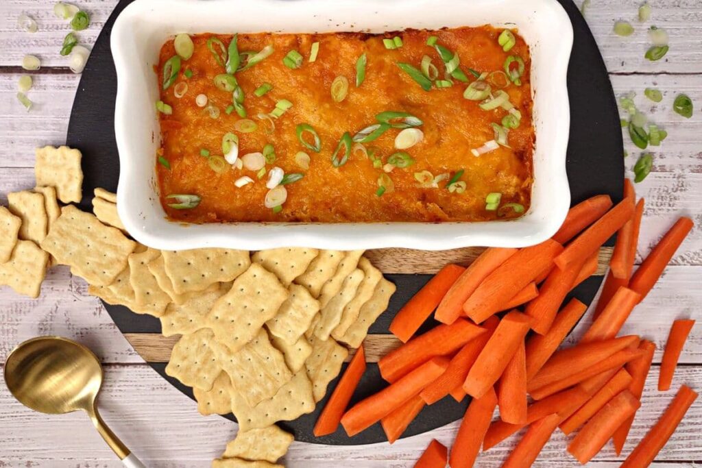 overhead view of buffalo chicken dip made in the air fryer with crackers and carrots