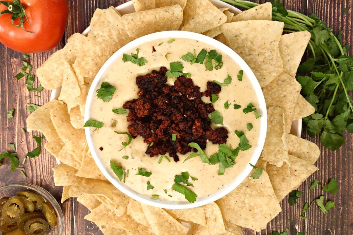 overhead view of queso dip with chorizo surrounded by tortilla chips