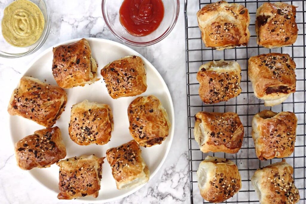 overhead view of sausage rolls circling a plate