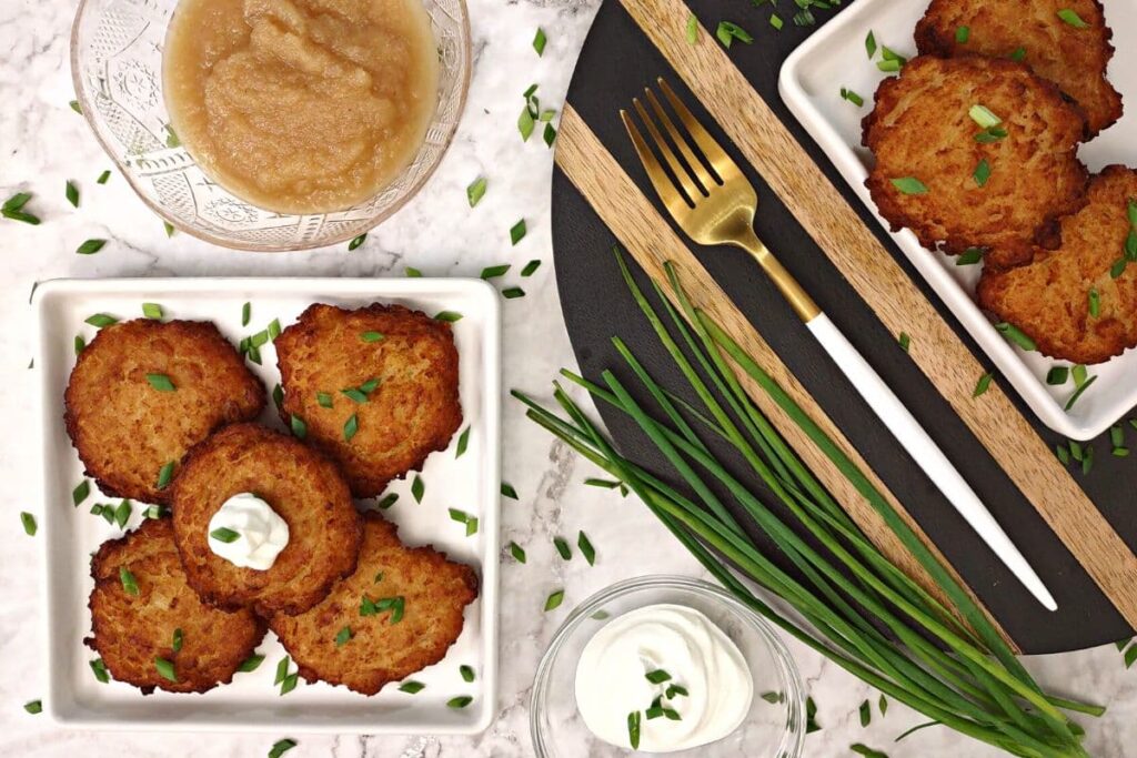 overhead view of trader joe's latkes on a plate with applesauce