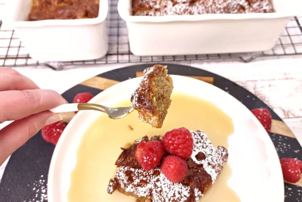 bite of air fryer french toast casserole on a fork over a hot and fresh piece
