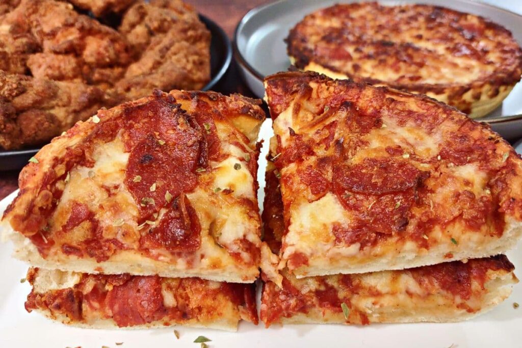 air fryer red baron deep dish pizza cut in four and stacked