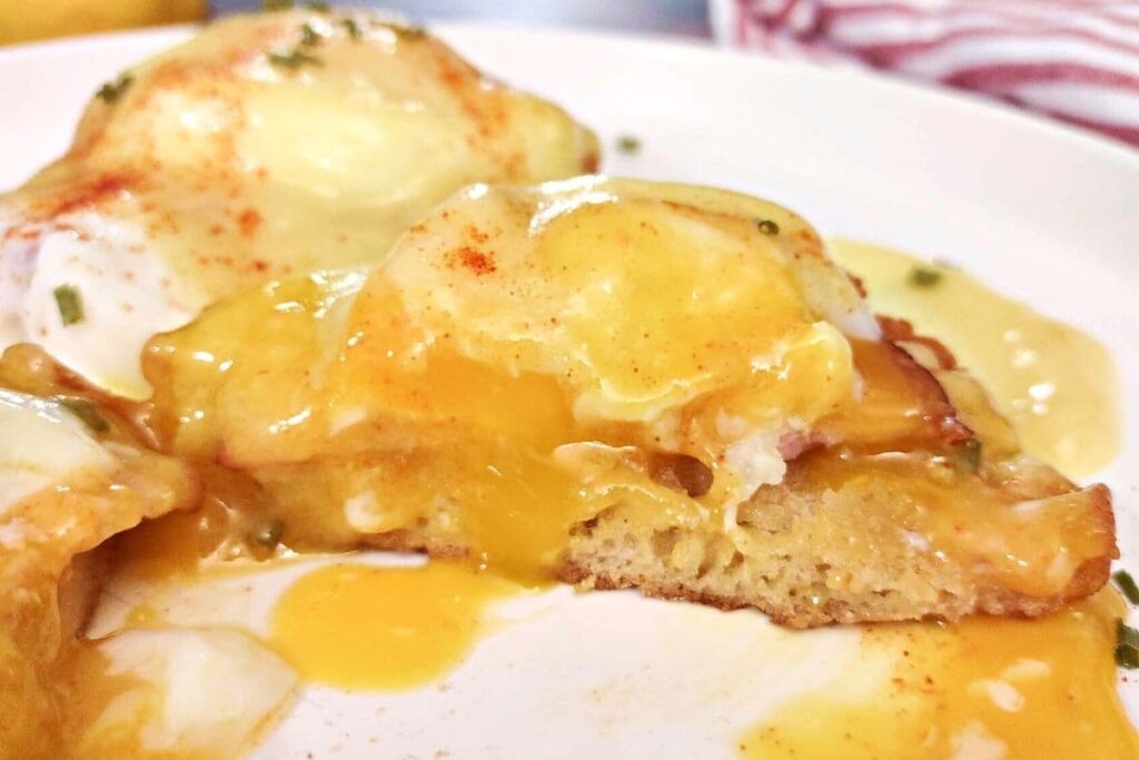 cross section of warm and gooey air fryer eggs benedict