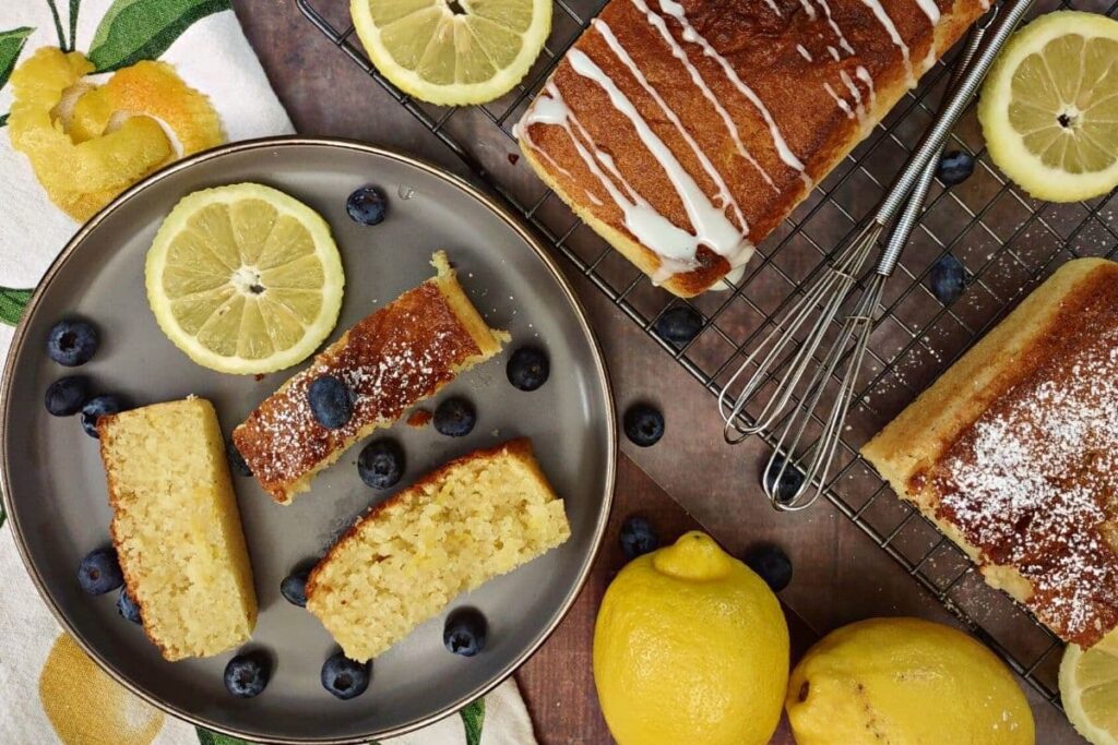 overhead view of air fryer lemon pound cake with fresh lemon and blueberries