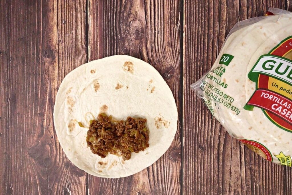 place a small amount of meat near the bottom of the tortilla