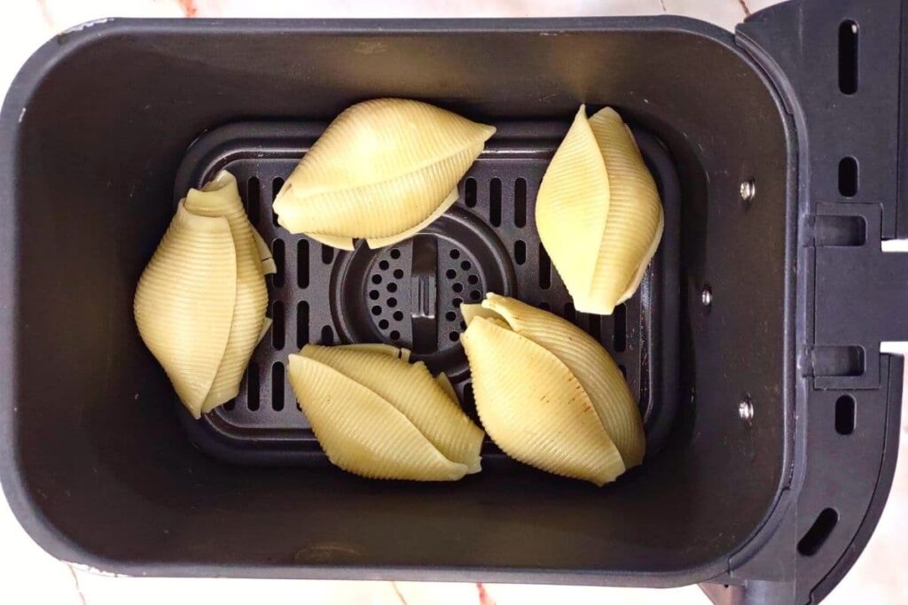 place taco stuffed shells in air fryer basket