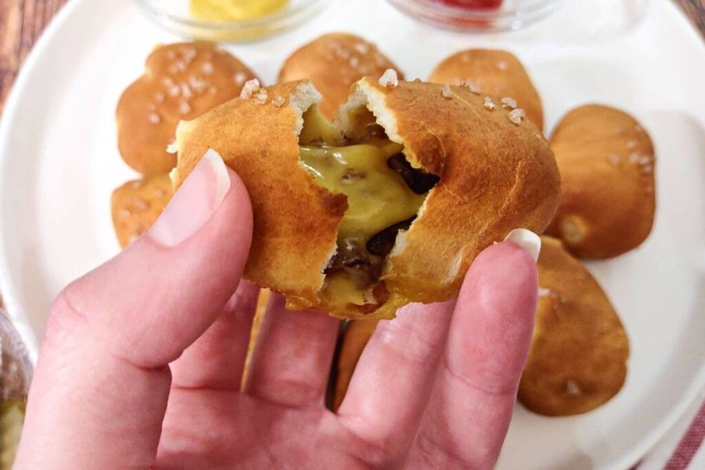 breaking open a pretzel bacon cheeseburger bomb with my hand