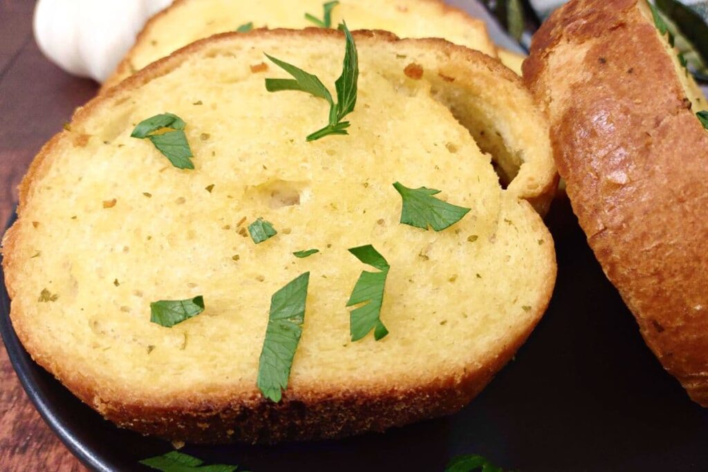 close up of air fryer texas toast on a plate with parsley